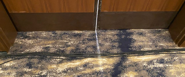 Bad Wiring Across Floor in Front of Doors